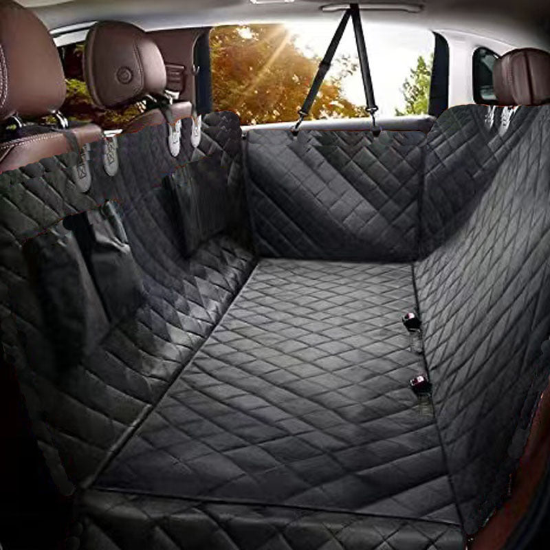 Black quilted waterproof rear seat hammock cover shielding car bench from mud, fur, and scratching claws with heavy-weave Oxford cloth.
